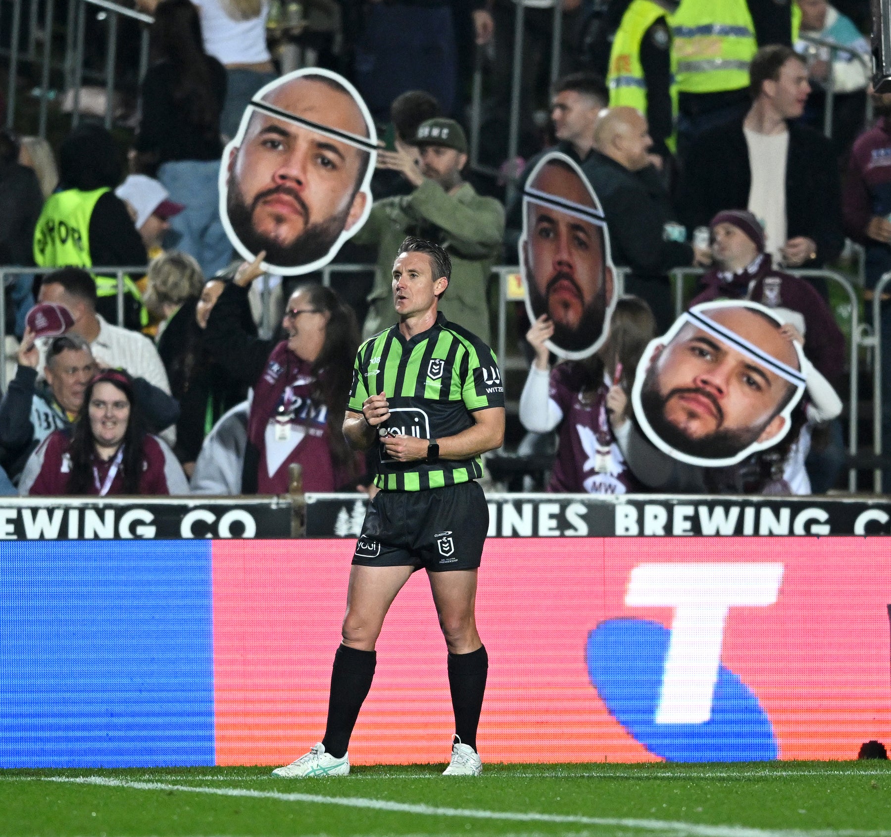 Supporters holding Sports Heads at a live game
