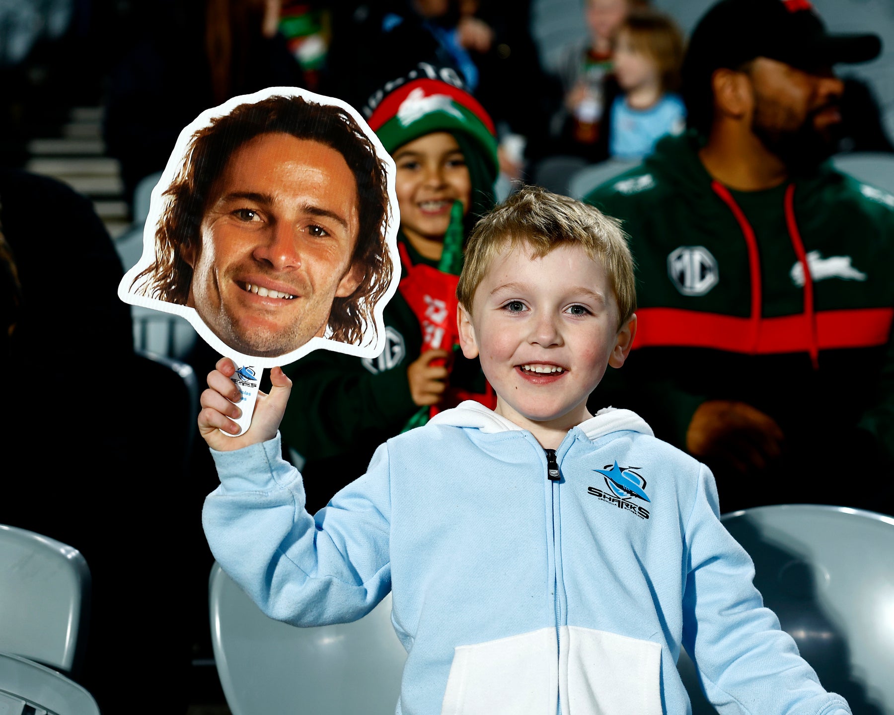 Supporters holding Sports Heads at a live game