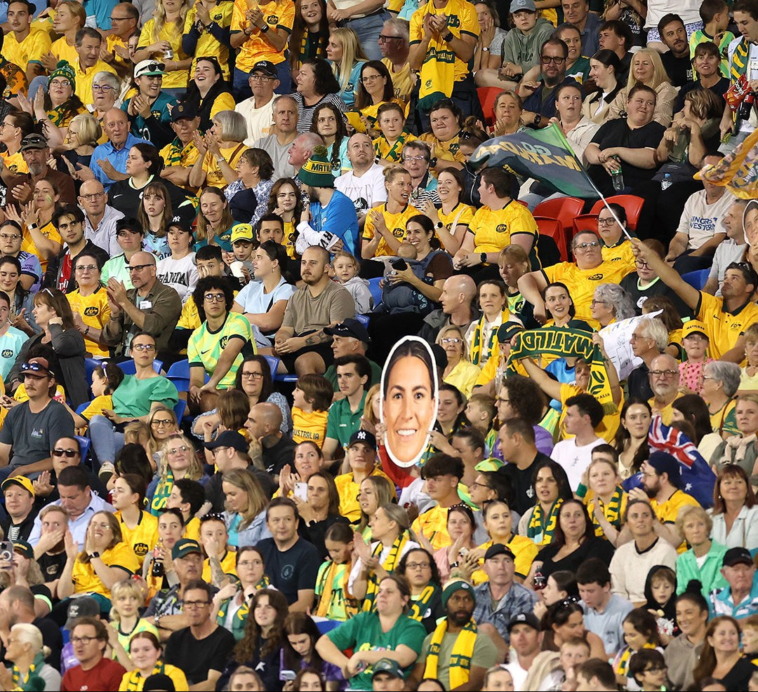 Supporters holding Sports Heads at a live game