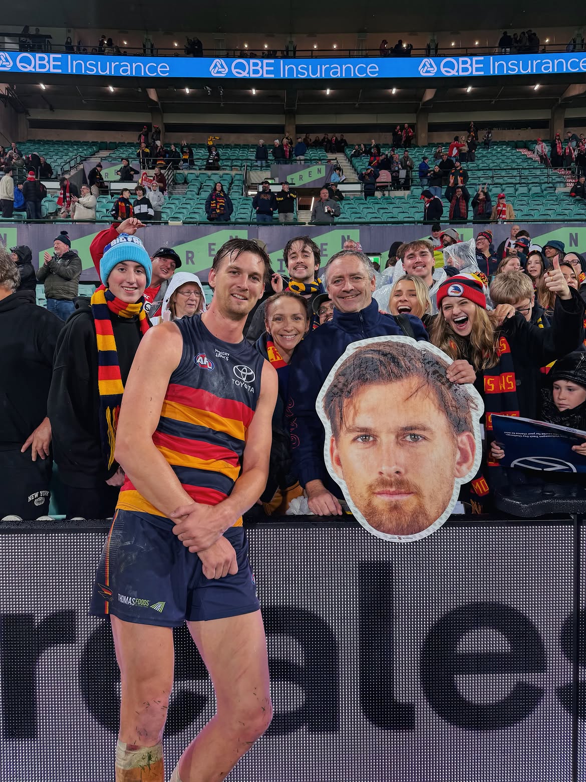 Supporters holding Sports Heads at a live game