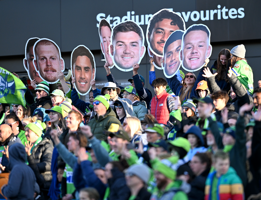 Supporters holding Sports Heads at a live game